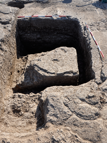 Fig. 4. Gabii, Area A, view of an assay pit dug in the bedrock south of the large quarry, from the west. Note the almost completely carved block, which was left on the bottom of the pit after being damaged.