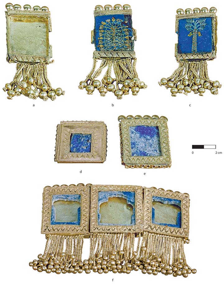 Fig. 9. Segments from forehead ornaments of gold, lapis lazuli, carnelian, and turquoise, probably from diadems with dorsal streamers. Segments b and c, respectively, depict a stylized and naturalistic palm tree. Ht. of longest segment (segment b) ca. 8 cm. Tomb II, Northwest Palace, Nimrud: a, ND 1989.32c; Baghdad, Iraq Museum, inv. no. 104815; b, ND 1989.32b; Iraq Museum, inv. no. 105814; c, ND 1989.32a; Iraq Museum, inv. no. 105813; d, ND 1989.41a; Iraq Museum, inv. no. 105828; e, ND 1989.41b; Iraq Museum, inv. no 105829; f, ND 1989.41c–e; Iraq Museum, inv. nos. 105830–32 (Hussein 2016, pl. 38; courtesy the Oriental Institute of the University of Chicago). Note that the inventory number (104815) for segment a may be printed incorrectly in Hussein 2016, 79. Because all the other segments in this assemblage have inventory numbers beginning with “105,” the correct inventory for segment a may be 105815.