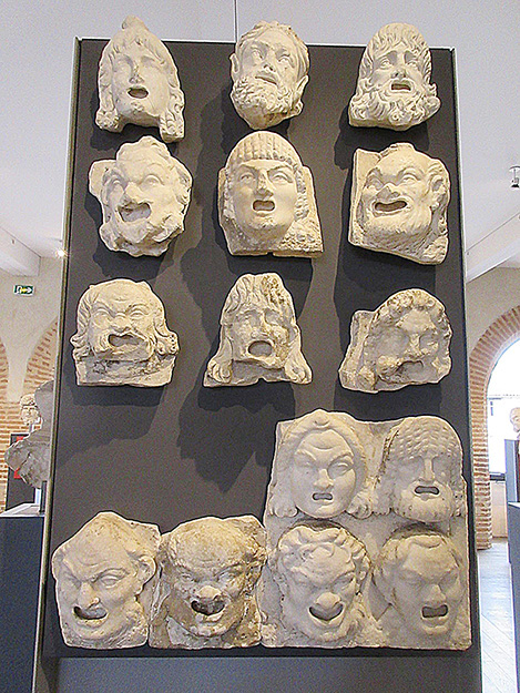 Fig. 5. Fragmentary relief plaques of theater masks, average ht. 27 cm, Chiragan. Toulouse, Musée Saint-Raymond, inv. nos. Ra 35 (1) to (12).