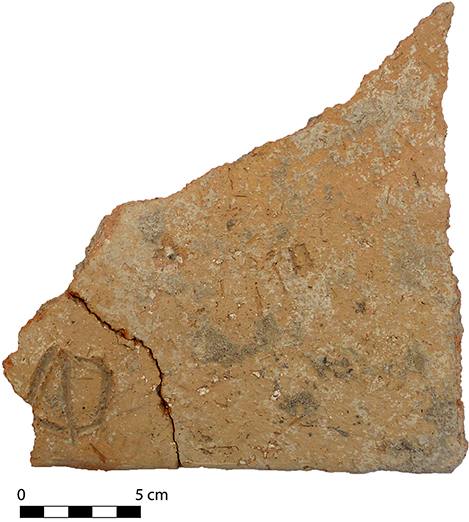 Fig. 10. Roof tile fragment with an incised sign, from the burnt destruction of the Northwest Complex.