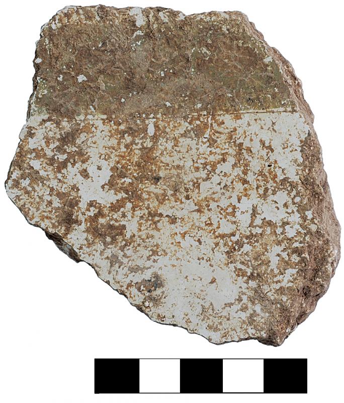 Fig. 7. Fragment (3055–13a) of thick white plaster decorated with a dark band, perhaps brown or black, possibly a fragment from a painted floor, from area D-South.